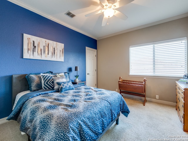 carpeted bedroom featuring crown molding and ceiling fan