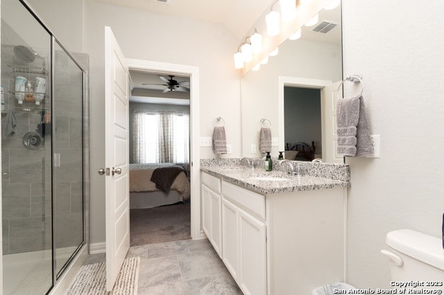 bathroom featuring walk in shower, ceiling fan, vanity, and toilet