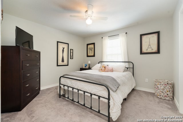 bedroom featuring ceiling fan and light colored carpet