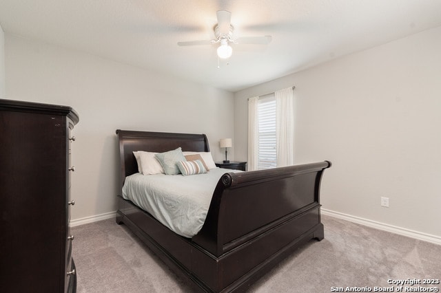 bedroom with light colored carpet and ceiling fan