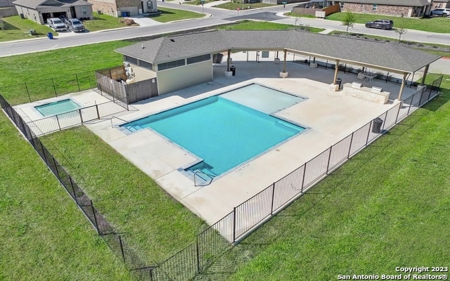 view of swimming pool featuring a lawn and a patio area