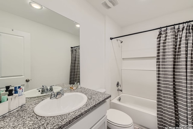 full bathroom with shower / bath combination with curtain, vanity, and toilet