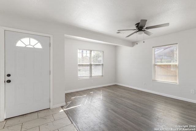 entryway featuring ceiling fan, light wood-type flooring, and plenty of natural light