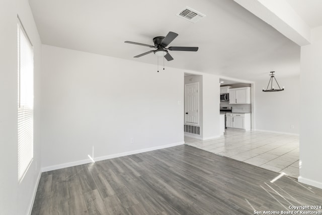 unfurnished living room with light wood-type flooring and ceiling fan