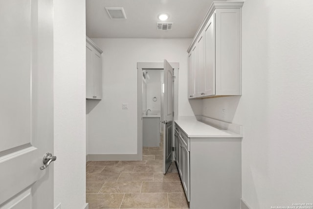 clothes washing area featuring sink