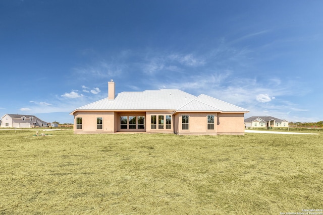 rear view of property with a lawn