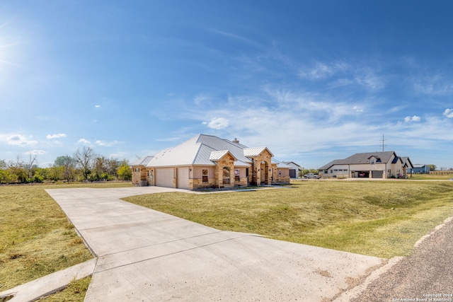 view of front of property featuring a garage and a front lawn