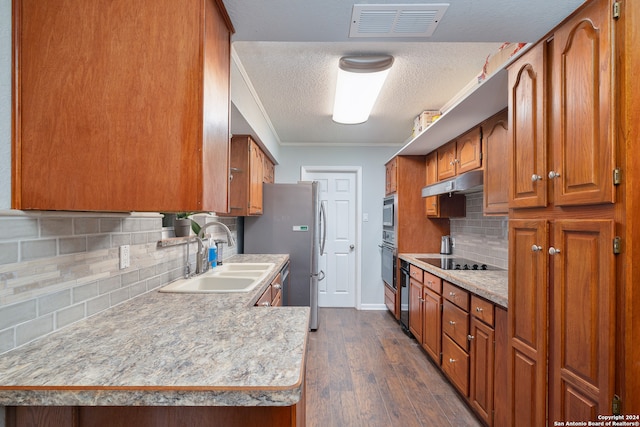 kitchen featuring sink, backsplash, black appliances, crown molding, and dark hardwood / wood-style flooring