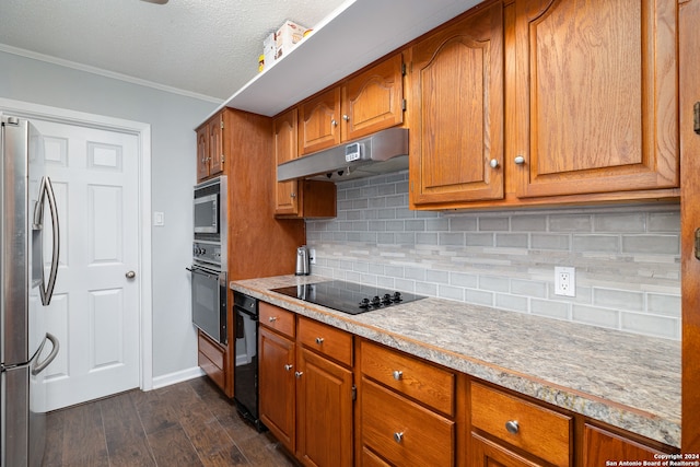 kitchen featuring ornamental molding, a textured ceiling, dark wood-type flooring, black appliances, and decorative backsplash