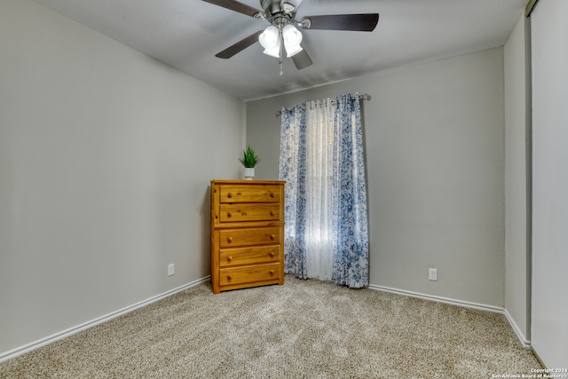 unfurnished bedroom with ceiling fan and light colored carpet