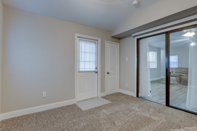 interior space featuring carpet floors and lofted ceiling