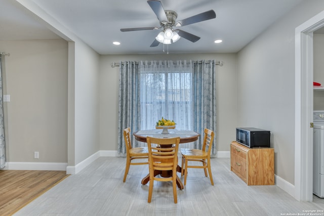 dining room with ceiling fan and light hardwood / wood-style flooring