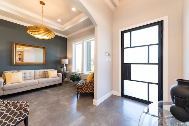 interior space featuring a raised ceiling and ornamental molding