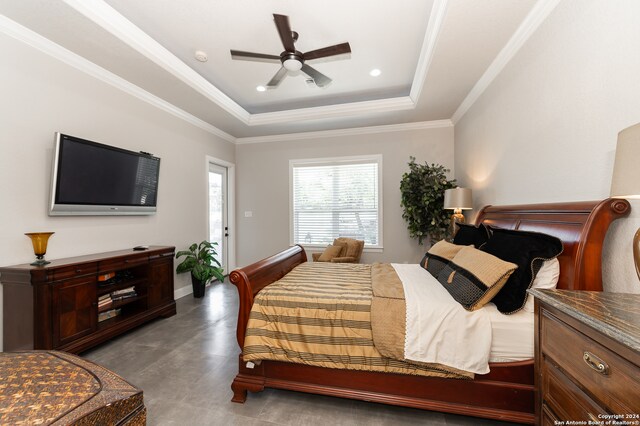 bedroom featuring ceiling fan, a tray ceiling, and crown molding