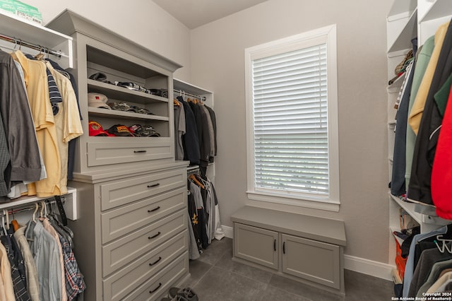 walk in closet featuring dark tile patterned flooring