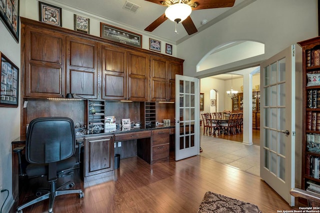 home office featuring french doors, ornamental molding, ceiling fan with notable chandelier, and light hardwood / wood-style floors