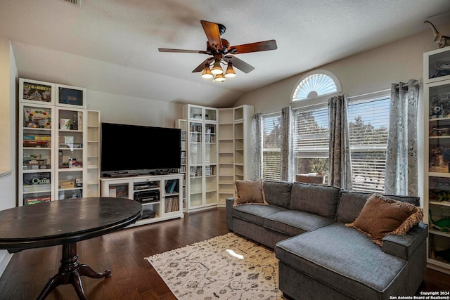 living room featuring a textured ceiling, ceiling fan, vaulted ceiling, and dark hardwood / wood-style flooring