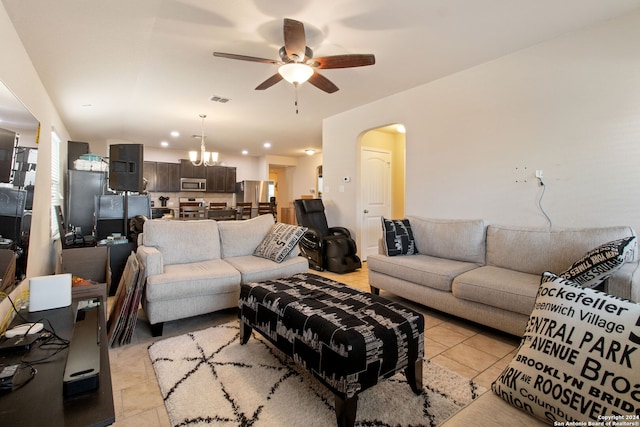 living room with ceiling fan with notable chandelier and light tile patterned floors