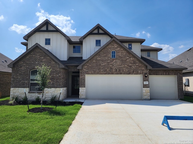 view of front of property featuring concrete driveway, a garage, board and batten siding, and stone siding