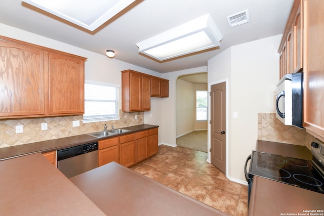 kitchen featuring appliances with stainless steel finishes, decorative backsplash, and sink