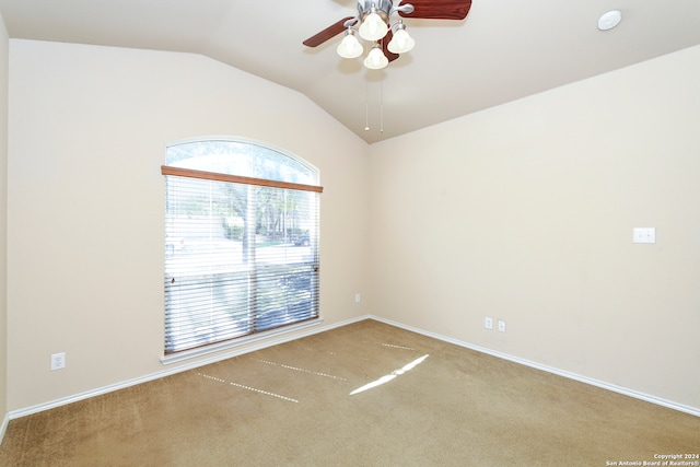 carpeted spare room with lofted ceiling and ceiling fan