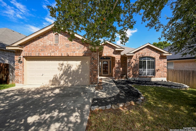 ranch-style house with a front yard and a garage