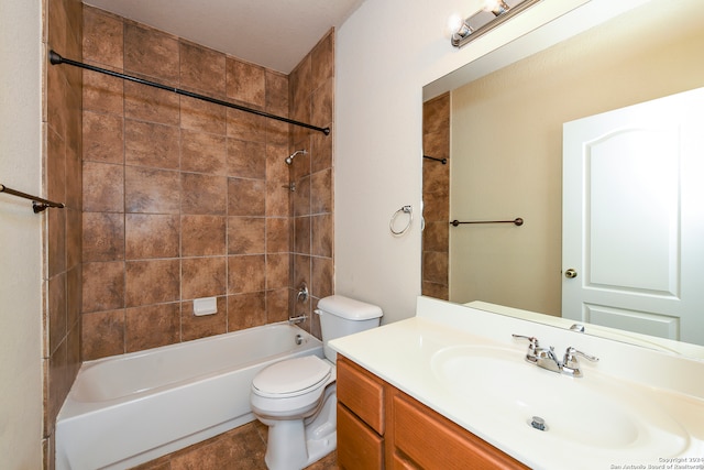 full bathroom featuring tiled shower / bath, vanity, toilet, and tile patterned floors