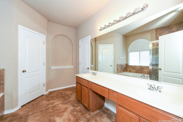 bathroom with plus walk in shower, tile patterned floors, and vanity