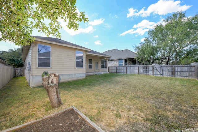 back of property featuring a lawn