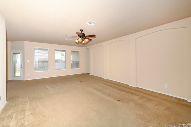 interior space featuring light carpet and ceiling fan