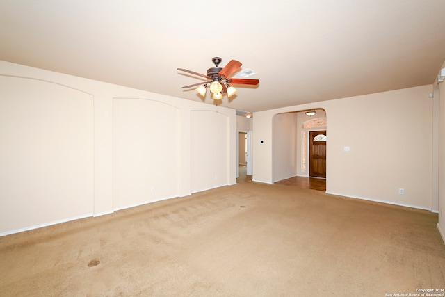 spare room with ceiling fan and light colored carpet