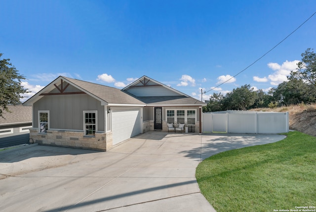 view of front of home with a front lawn and a garage