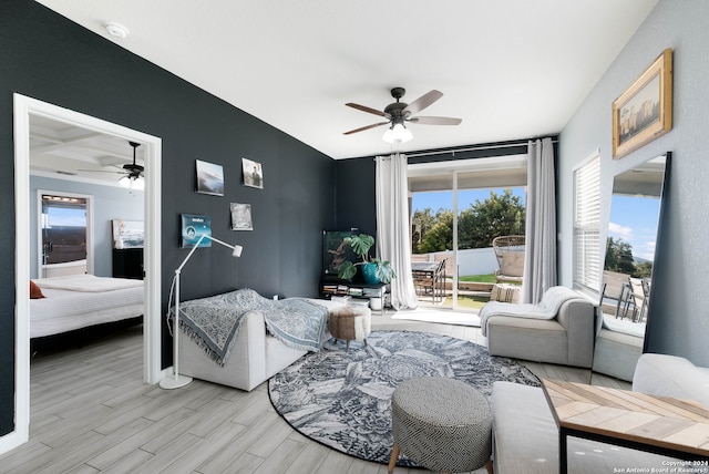 living room featuring light hardwood / wood-style flooring and ceiling fan