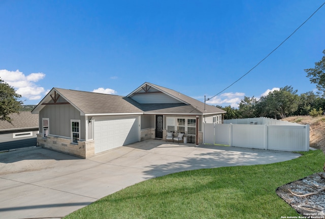 view of front of property featuring a front yard and a garage