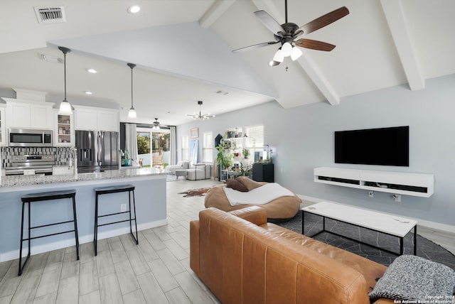 living room with beamed ceiling, ceiling fan with notable chandelier, light hardwood / wood-style floors, and high vaulted ceiling