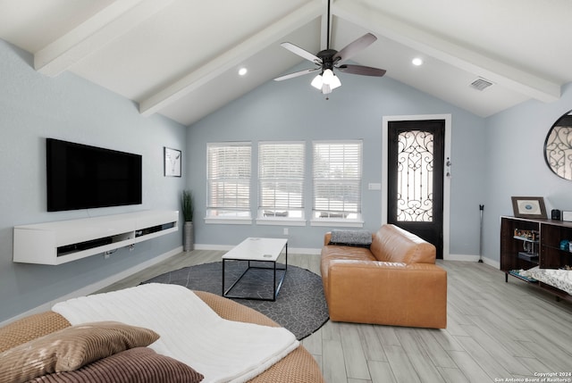 living room featuring lofted ceiling with beams, light wood-type flooring, and ceiling fan