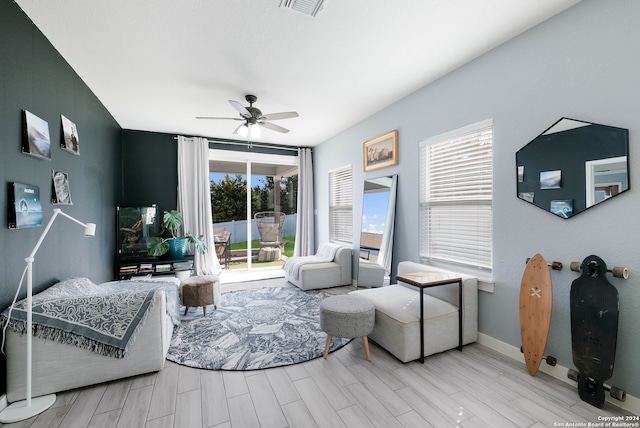 living room featuring ceiling fan and light hardwood / wood-style flooring