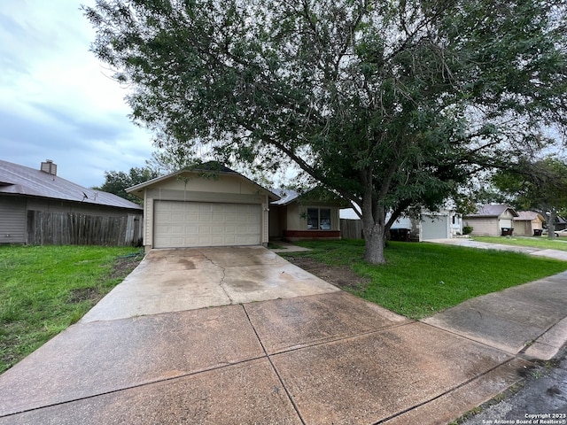 single story home featuring a front yard and a garage