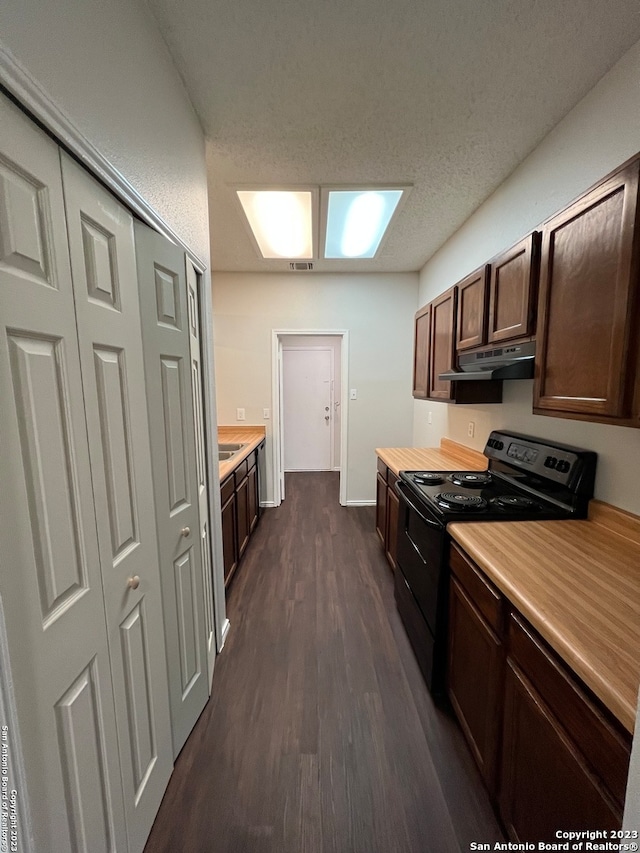 kitchen featuring a skylight, dark brown cabinets, a textured ceiling, black / electric stove, and dark hardwood / wood-style flooring