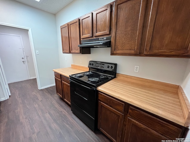 kitchen with dark wood-type flooring, electric range, and a textured ceiling