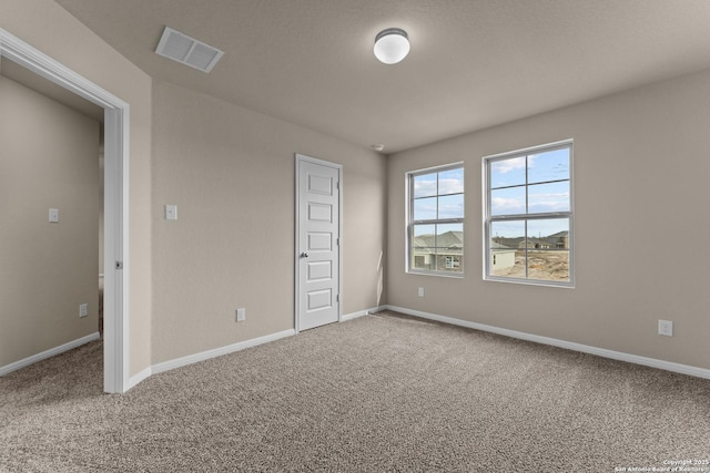 unfurnished bedroom featuring carpet flooring and a closet