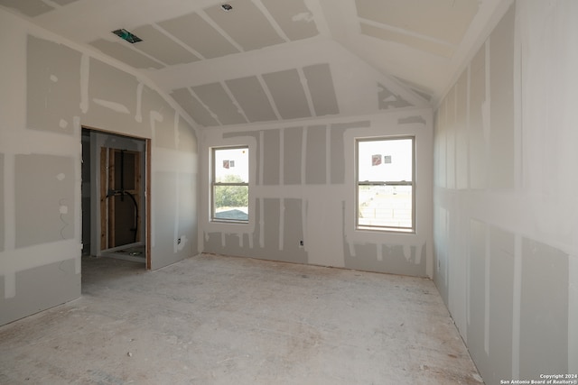 spare room with lofted ceiling