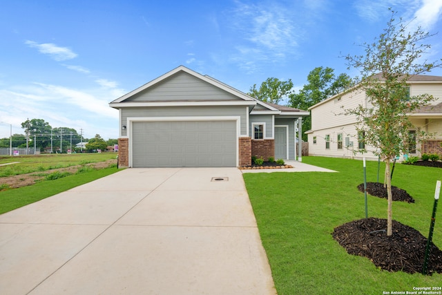 view of front of home with a garage and a front yard