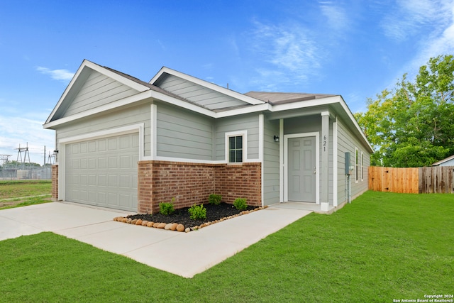 view of front of home with a front yard and a garage