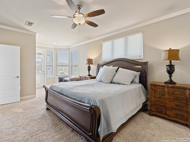 carpeted bedroom with ornamental molding and ceiling fan