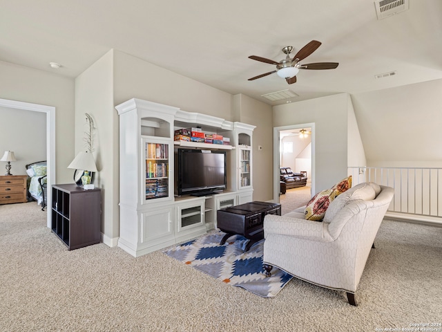 living room with ceiling fan and light colored carpet