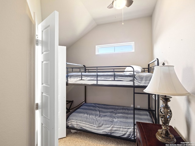 carpeted bedroom featuring lofted ceiling and ceiling fan