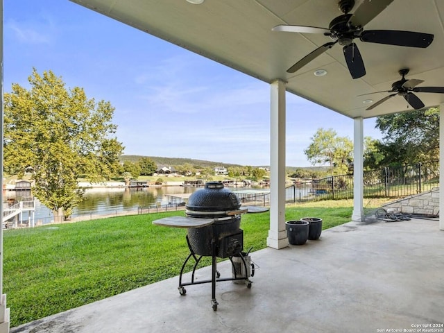 view of patio / terrace featuring a water view and ceiling fan