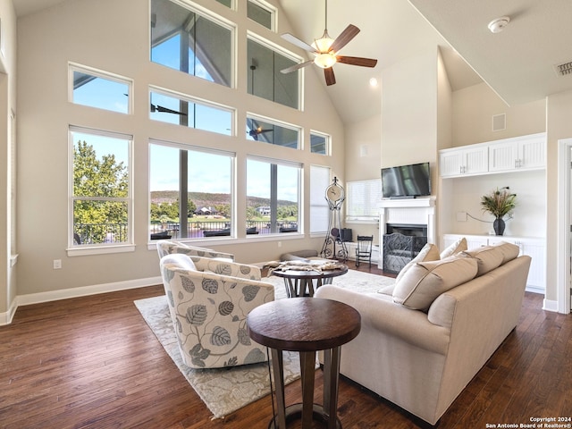 living room featuring high vaulted ceiling, dark hardwood / wood-style flooring, and ceiling fan