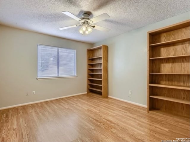 unfurnished bedroom featuring ceiling fan, a textured ceiling, and light hardwood / wood-style flooring